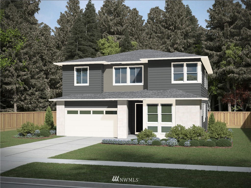 a front view of a house with a garden and yard