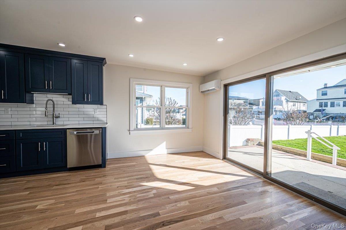 55 Alhambra Road Massapequa, NY 11758 - Photo 11 of 38 a kitchen with stainless steel appliances granite countertop a stove a sink and a refrigerator