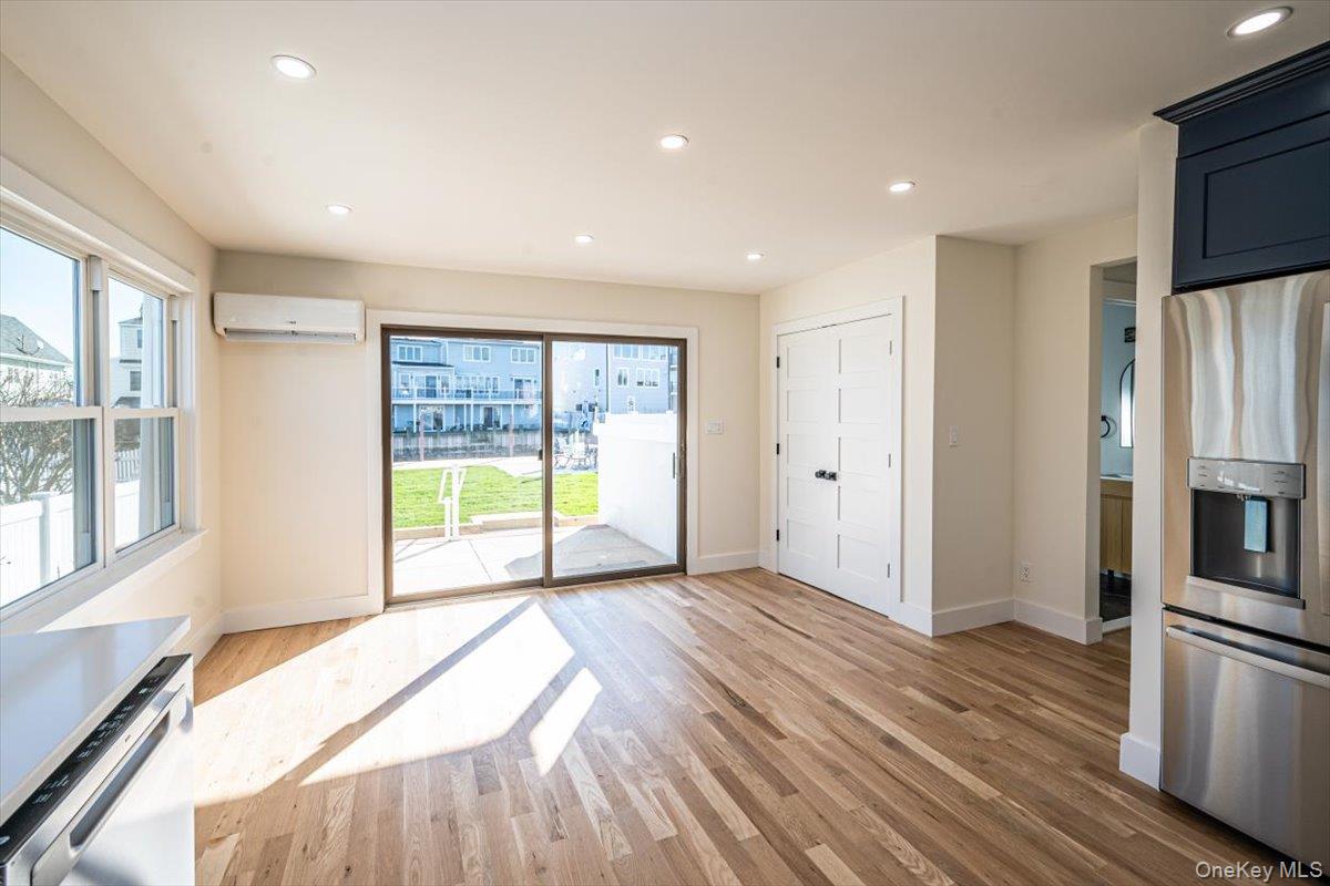 55 Alhambra Road Massapequa, NY 11758 - Photo 12 of 38 a view of a kitchen with a stove fridge and wooden floor
