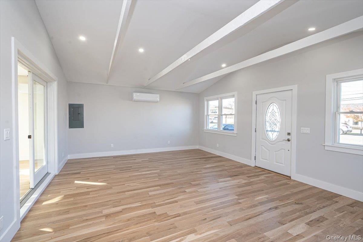 55 Alhambra Road Massapequa, NY 11758 - Photo 15 of 38 a view of an empty room with wooden floor and a window