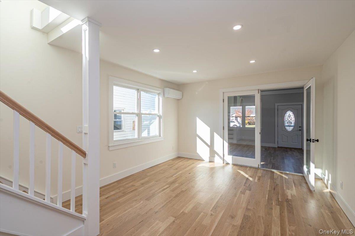 55 Alhambra Road Massapequa, NY 11758 - Photo 18 of 38 a view of empty room with wooden floor and fan