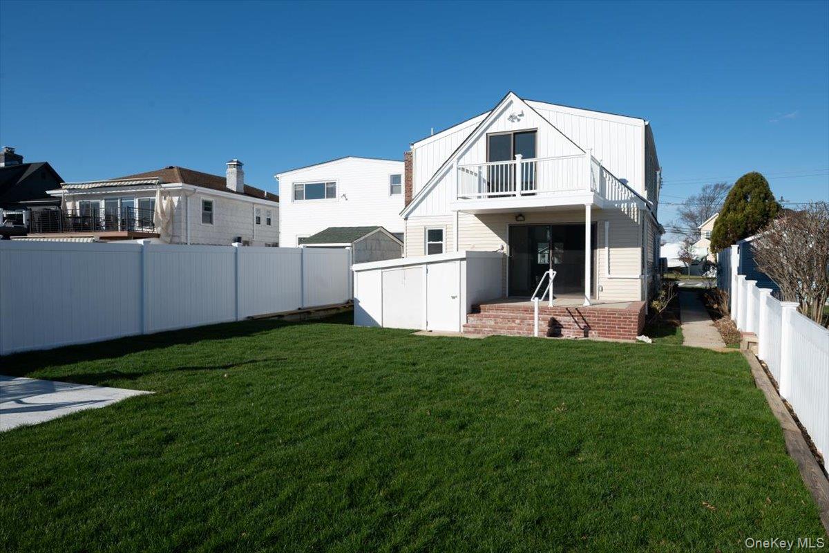 55 Alhambra Road Massapequa, NY 11758 - Photo 2 of 38 a front view of a house with a yard
