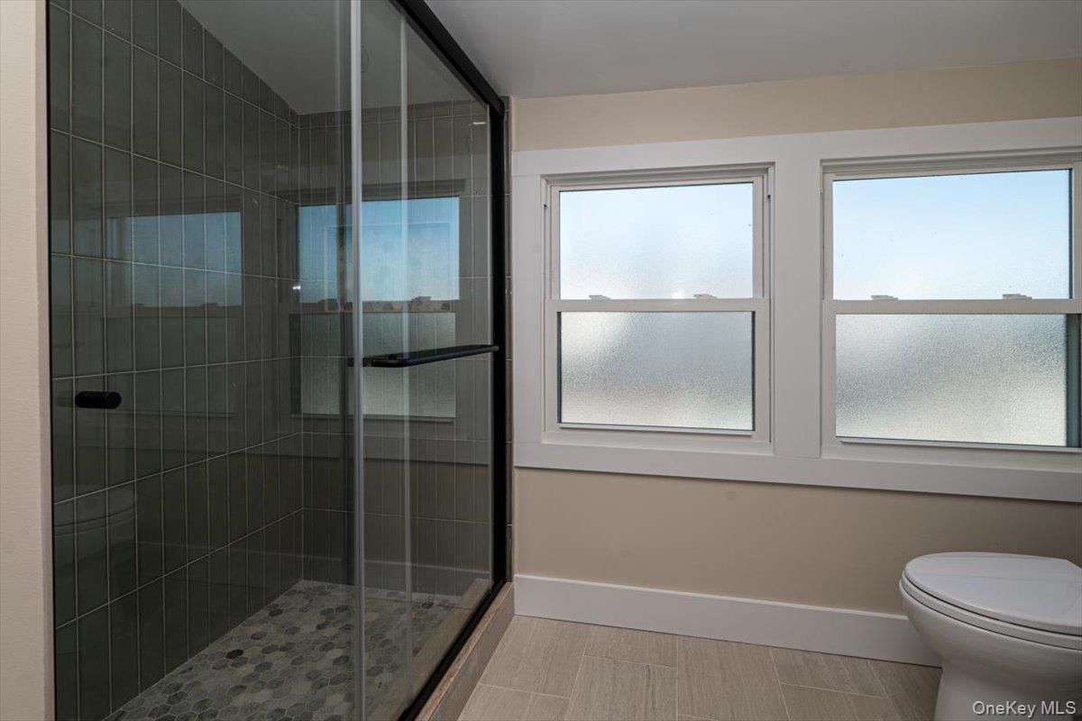 55 Alhambra Road Massapequa, NY 11758 - Photo 27 of 38 a bathroom with a toilet and a shower