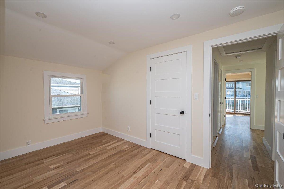 55 Alhambra Road Massapequa, NY 11758 - Photo 30 of 38 an empty room with wooden floor and windows