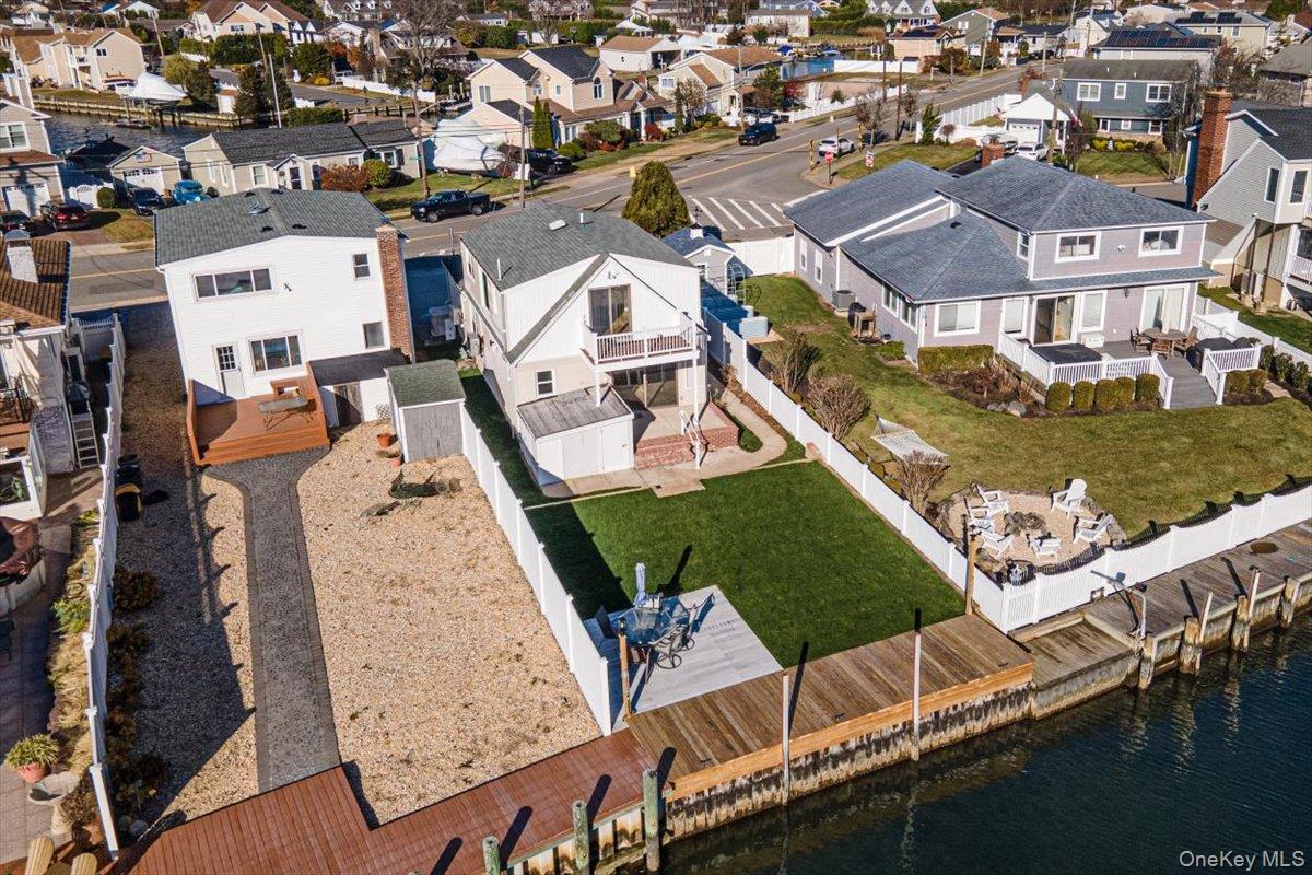 55 Alhambra Road Massapequa, NY 11758 - Photo 5 of 38 an aerial view of a house with a garden and lake view