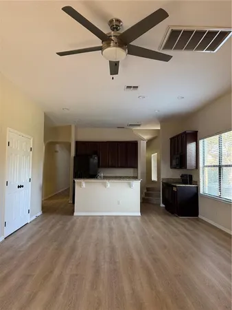 a spacious bathroom with a granite countertop sink a toilet and shower