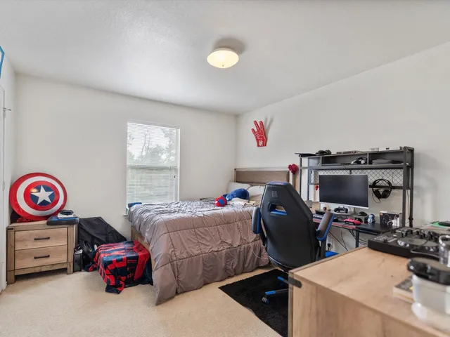 a bedroom with bed and a chandelier