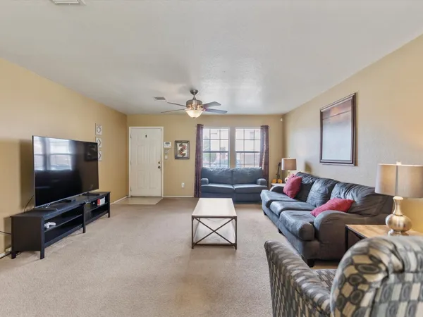 a living room with furniture and a flat screen tv