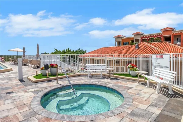 a house view with pool and chairs