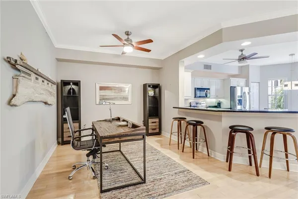 a living room with furniture a ceiling fan and a rug