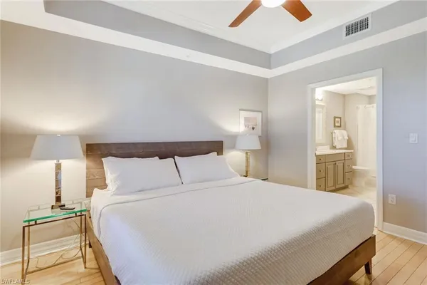 a bedroom with a bed and a lamp