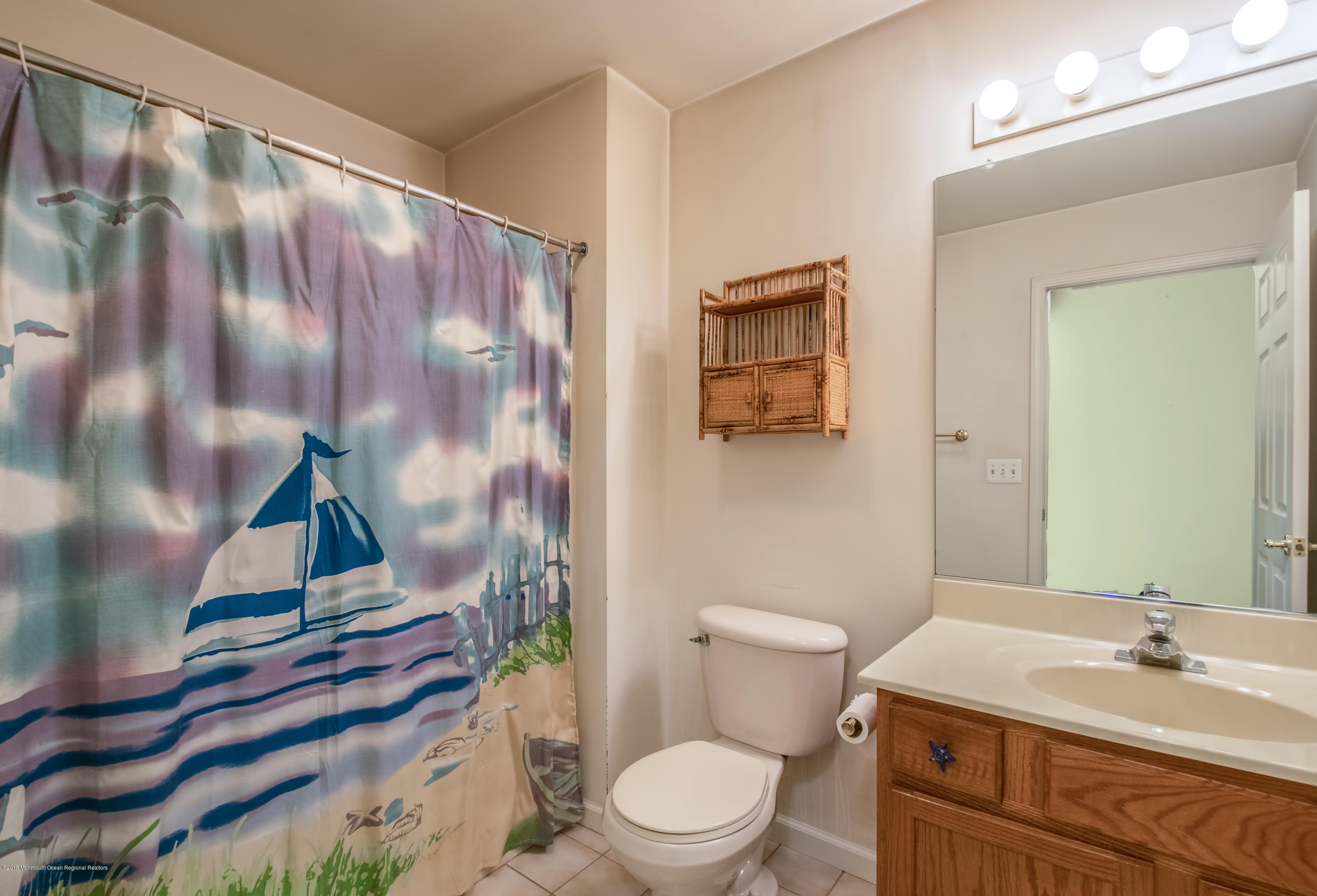 124 Marlin Road Manahawkin, NJ 08050 - Photo 14 of 34 a bathroom with a sink and mirror with toilet