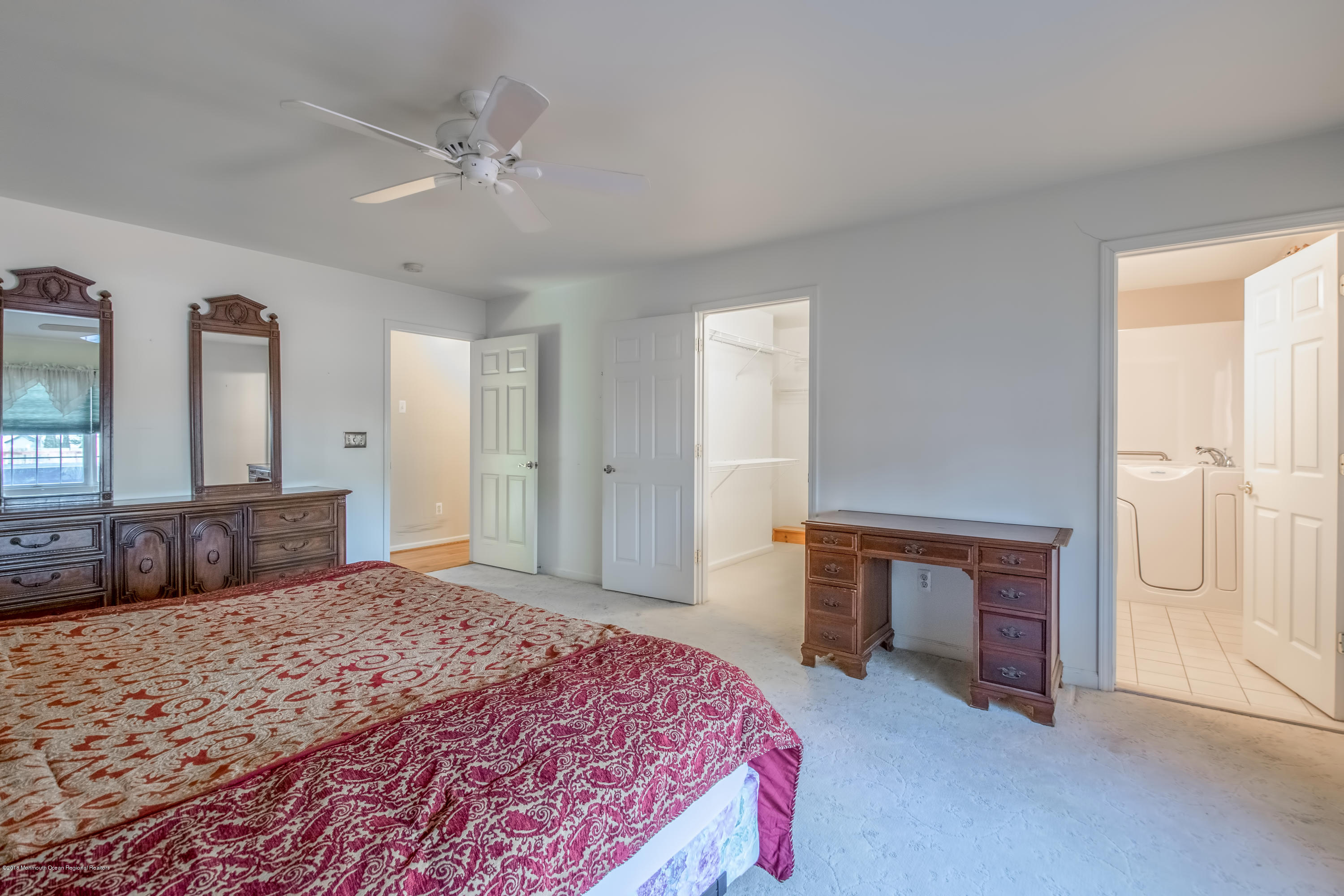 124 Marlin Road Manahawkin, NJ 08050 - Photo 16 of 34 a bedroom with a large bed and a chandelier