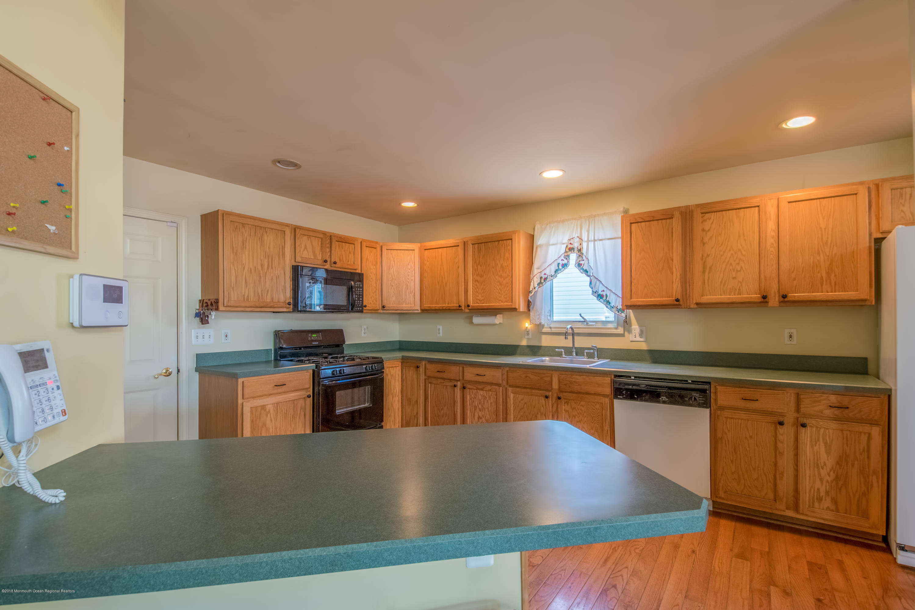 124 Marlin Road Manahawkin, NJ 08050 - Photo 5 of 34 a kitchen with stainless steel appliances granite countertop a stove a sink and a microwave