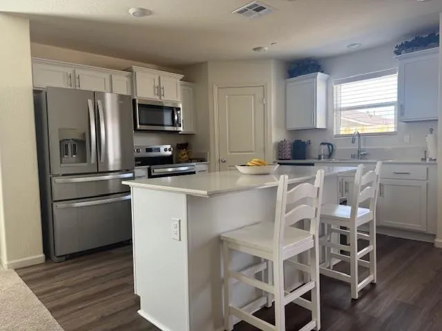 a kitchen with stainless steel appliances a refrigerator stove microwave and cabinets