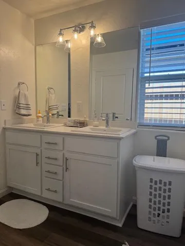 a bathroom with a sink a toilet and a mirror