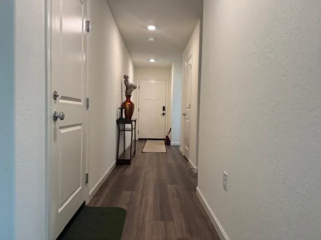 a view of a hallway with wooden floor