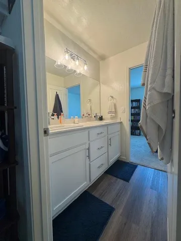 a kitchen with a sink cabinets and wooden floor