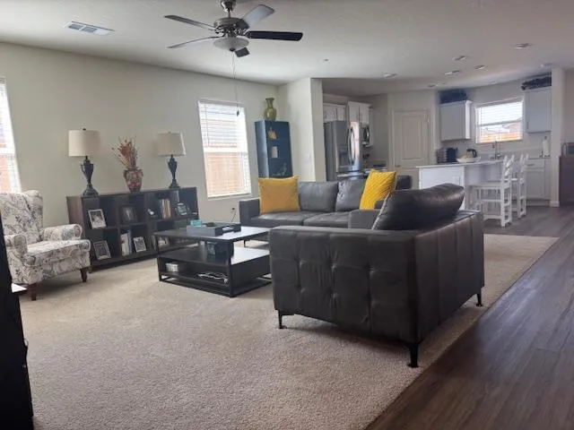 a living room with furniture and wooden floor