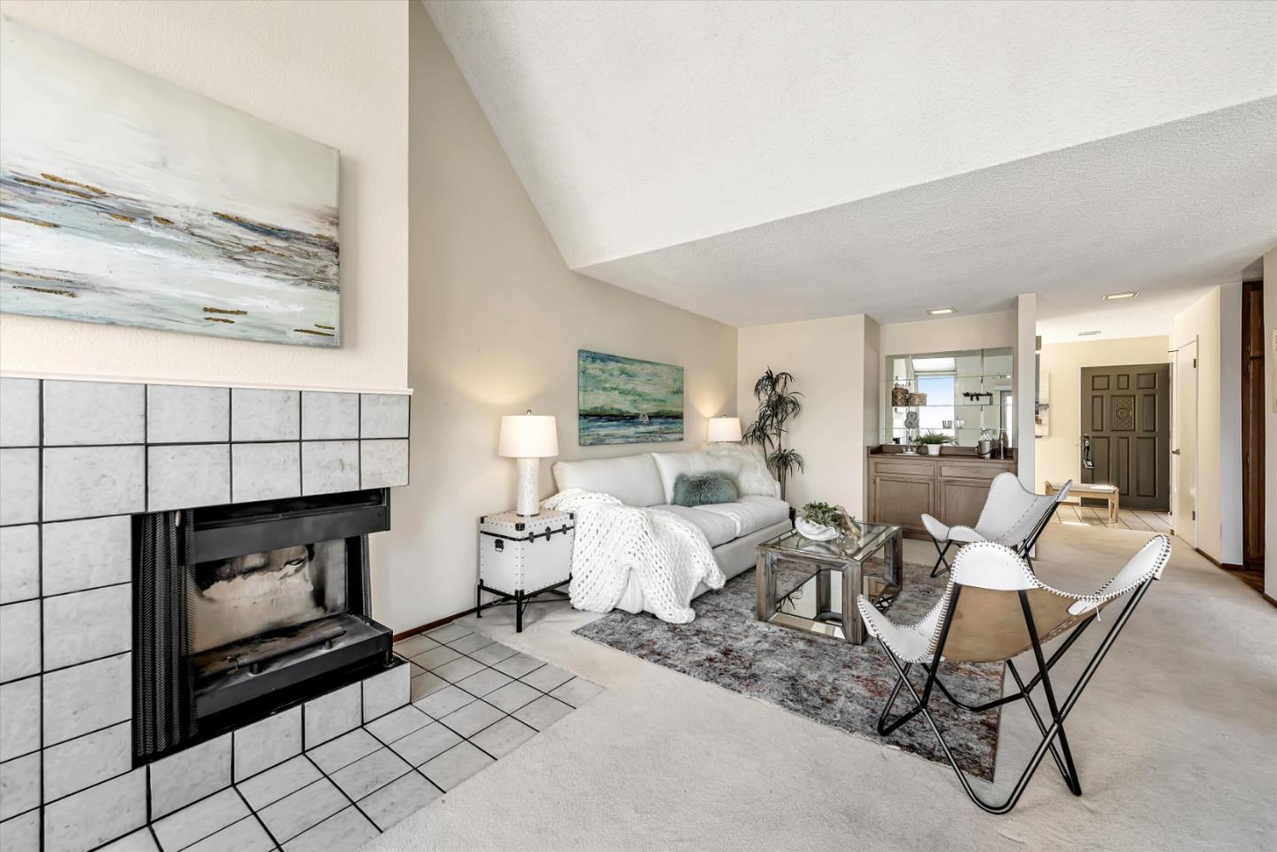 459 Roberts Road Pacifica, CA 94044 - Photo 10 of 50 a living room with furniture a fireplace and a floor to ceiling window