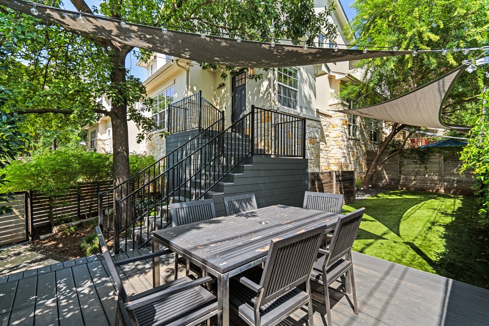 1609 Hartford Road, Unit A Austin, TX 78703 - Photo 5 of 39 Relax on this ample deck shaded by mature trees and a chic sun sail, perfect for outdoor gatherings.