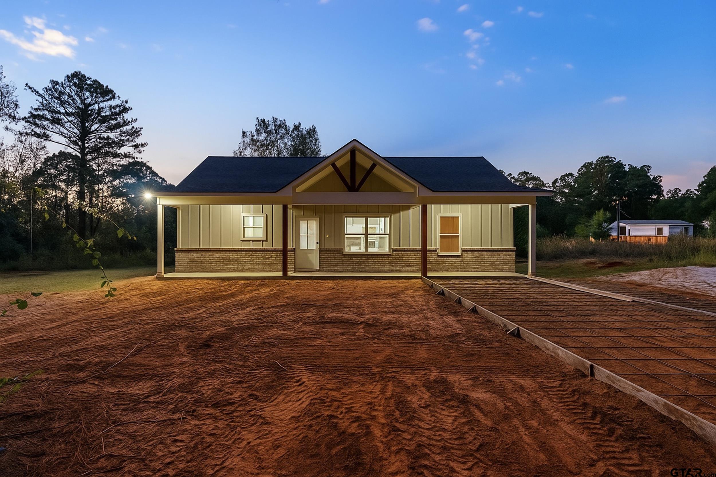 a front view of a house with a garden