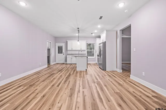 a view of kitchen with wooden floor and electronic appliances