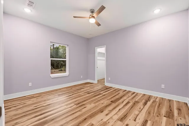 a view of room with window and ceiling fan