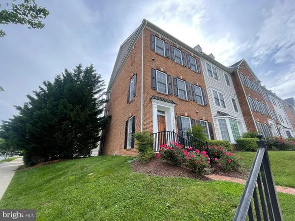 a view of a brick building next to a yard