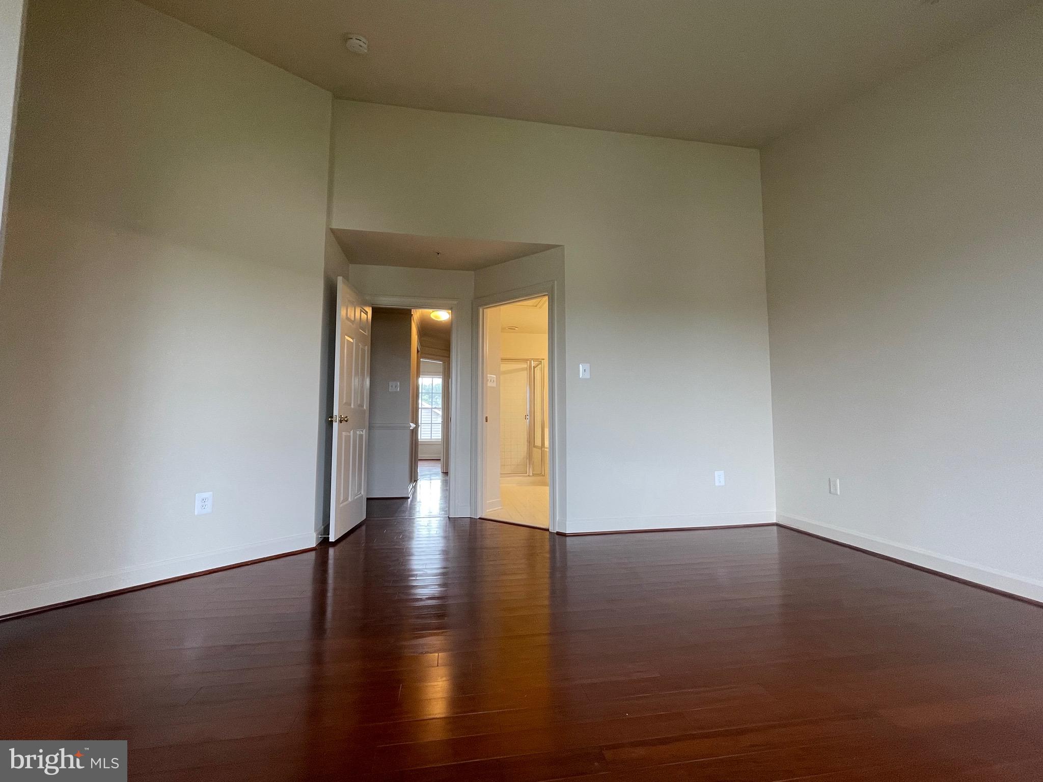 23402 Winemiller Way Clarksburg, MD 20871 - Photo 16 of 22 a view of an empty room with wooden floor and a window