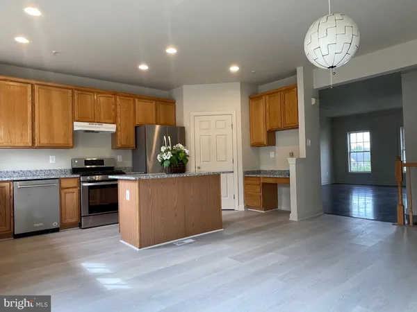 a kitchen with a stove and a refrigerator