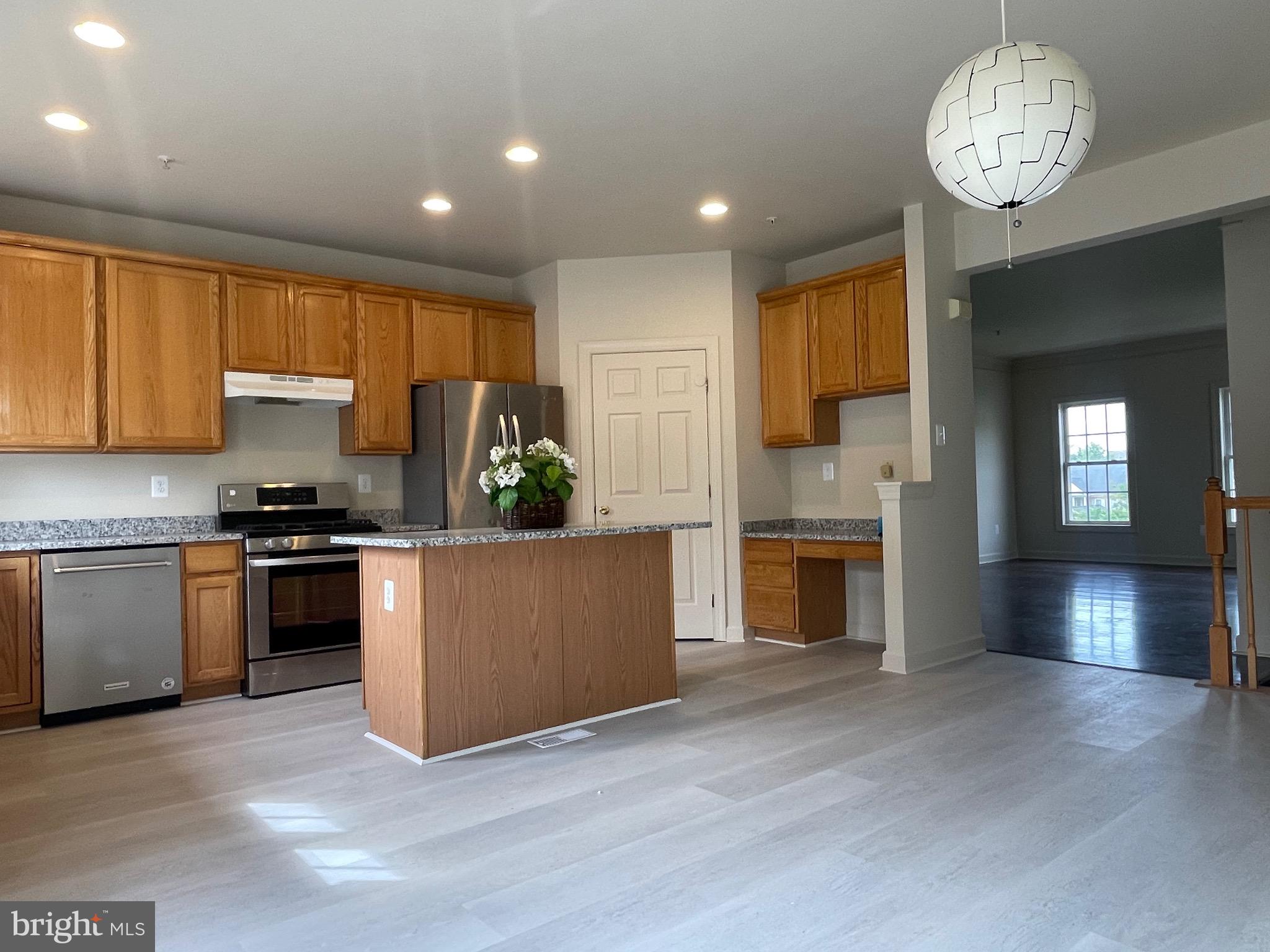 23402 Winemiller Way Clarksburg, MD 20871 - Photo 19 of 22 a kitchen with a stove and a refrigerator
