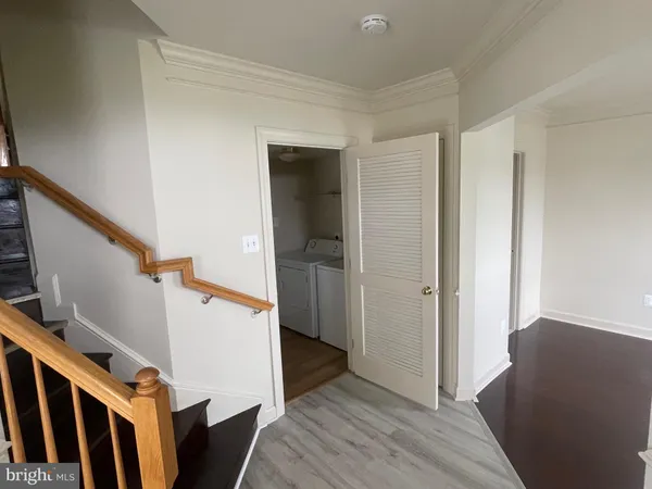 a view of entryway with wooden floor and stairs