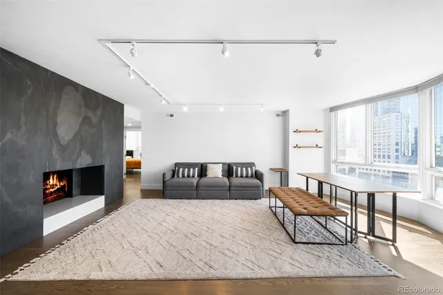 a kitchen with stainless steel appliances kitchen island granite countertop a dining table chairs sink and white cabinets