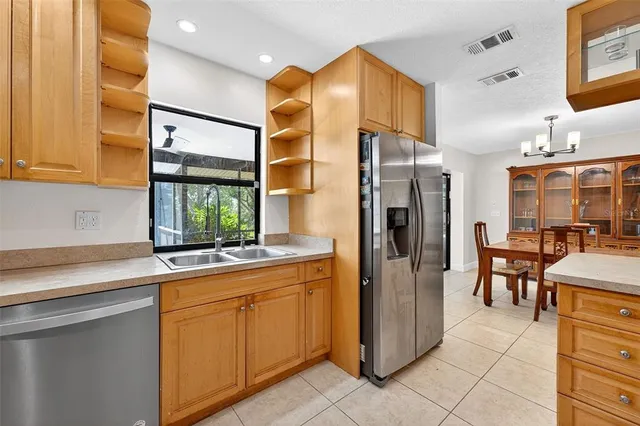 a kitchen with refrigerator and table