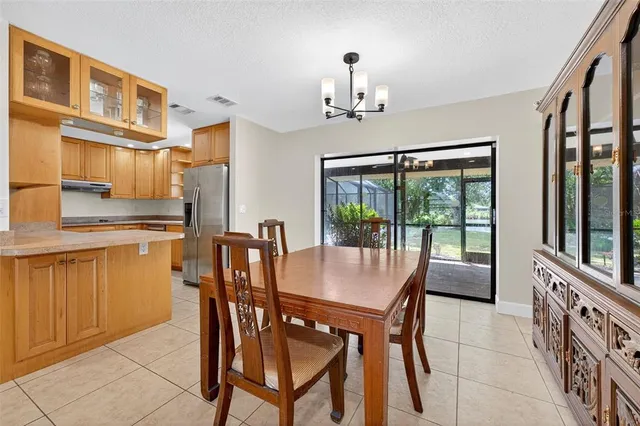 a dining room with furniture a chandelier and wooden floor