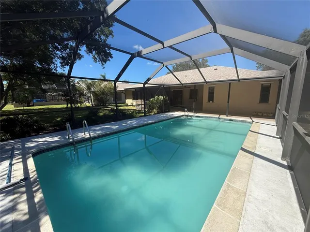 a view of a swimming pool with a patio