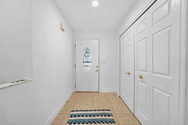 a view of a hallway with closet and wooden floor