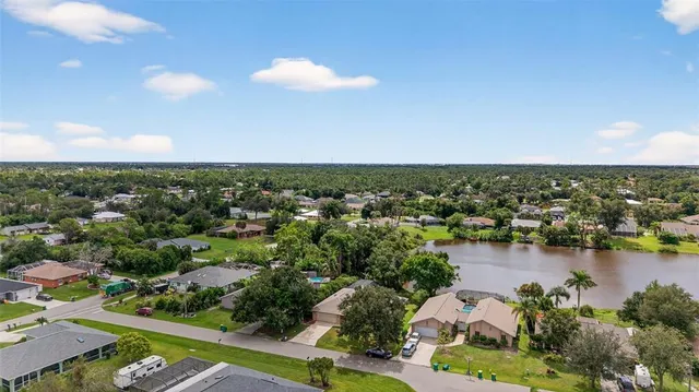 an aerial view of a house with a lake view