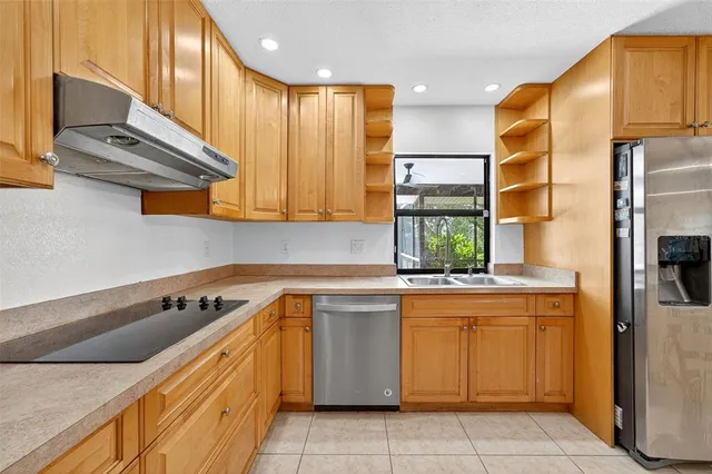 a kitchen with a sink cabinets and stainless steel appliances