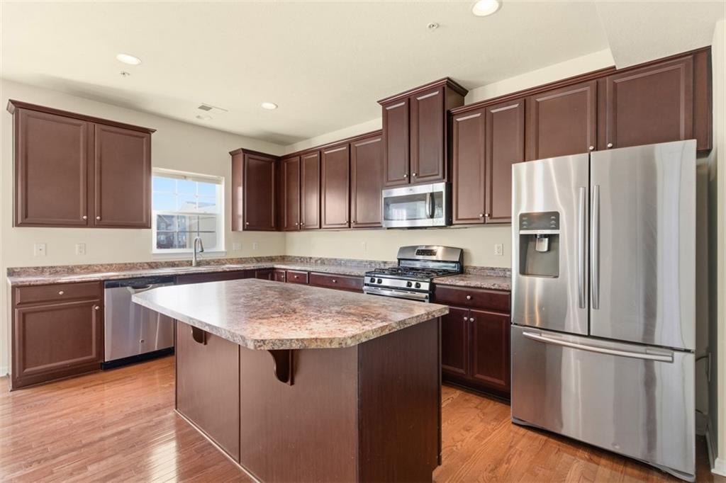 3001 Pointe View Drive Mars, PA 16046 - Photo 16 of 48 a kitchen with stainless steel appliances granite countertop a refrigerator a sink a stove a microwave and wooden cabinets
