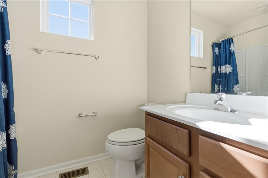 3001 Pointe View Drive Mars, PA 16046 - Photo 31 of 48 a bathroom with a granite countertop toilet a sink and a mirror