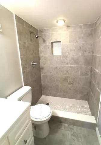 a bathroom with a toilet and a shower