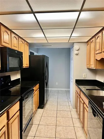 a kitchen with stainless steel appliances granite countertop a stove a microwave and a sink