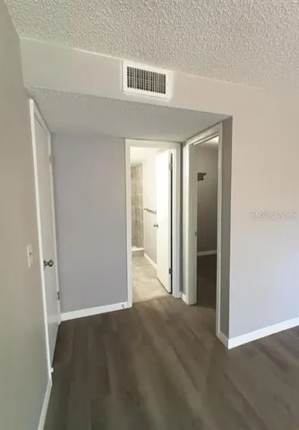 an empty room with closet and wooden floor