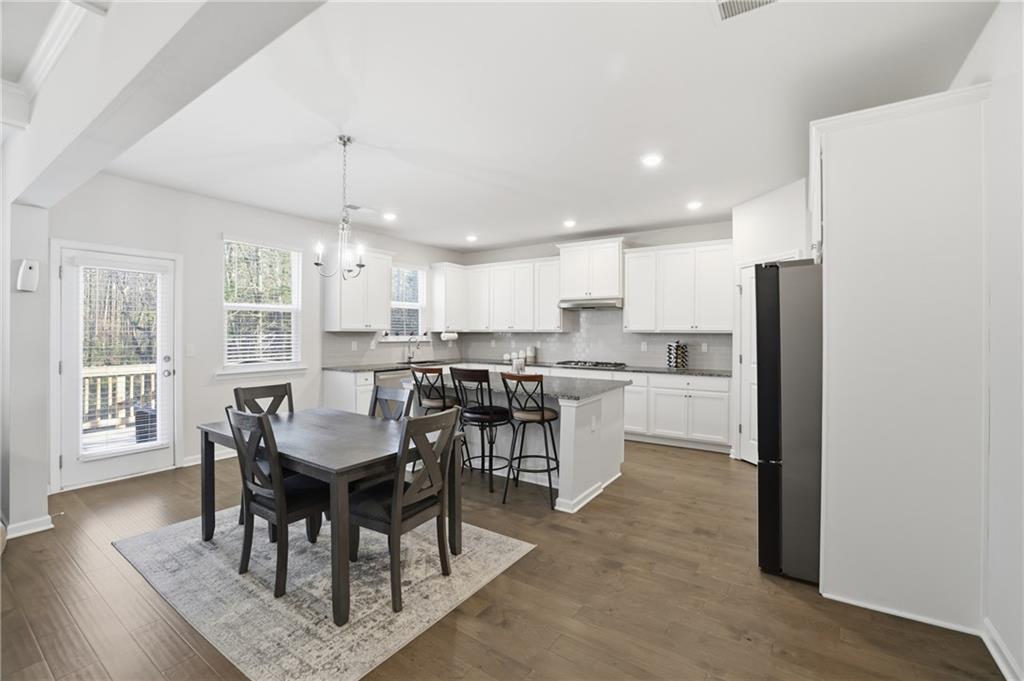 175 Paxton Lane Jefferson, GA 30549 - Photo 10 of 39 a living room with stainless steel appliances kitchen island granite countertop furniture and wooden floor