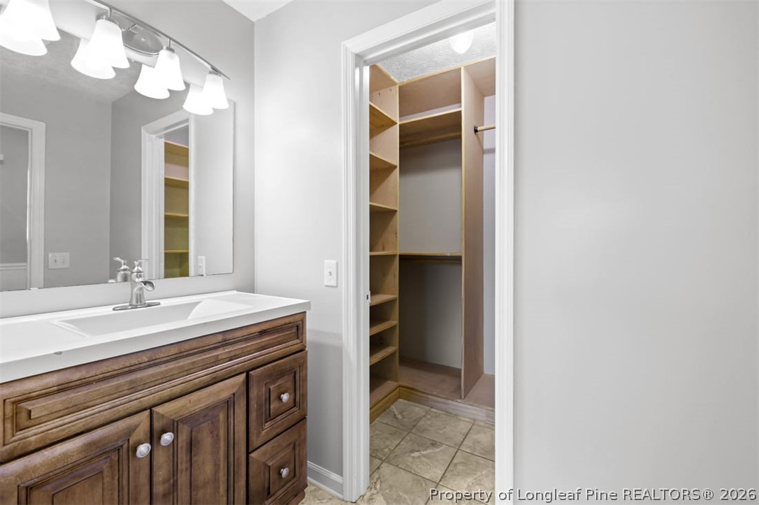 1205 Crossbend Court Fayetteville, NC 28314 - Photo 23 of 37 a bathroom with a sink and a mirror