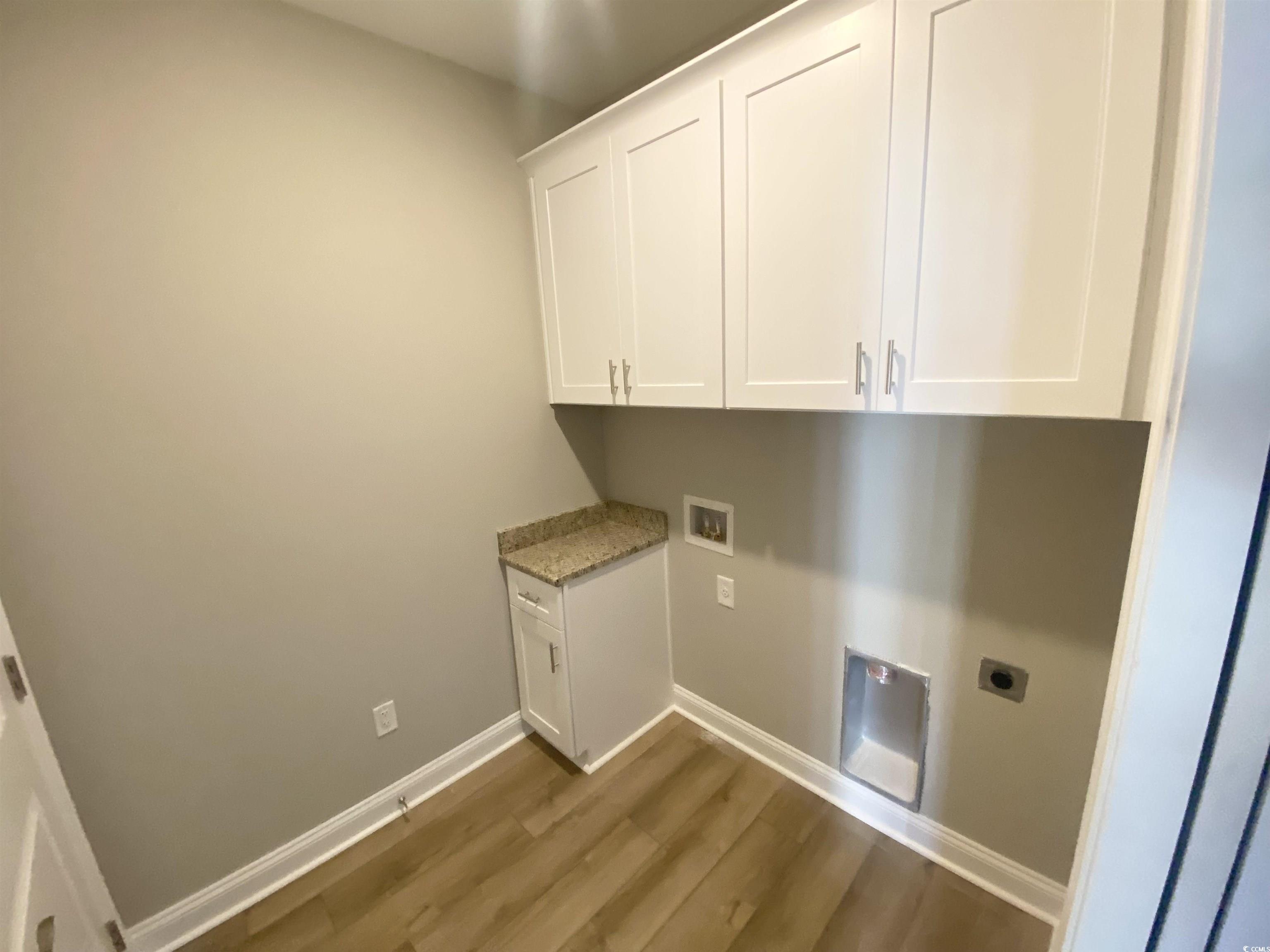 5553 Grape Arbor Lane Myrtle Beach, SC 29588 - Photo 28 of 35 Laundry room with cabinet space, dark wood finished floors, washer hookup, and electric dryer hookup