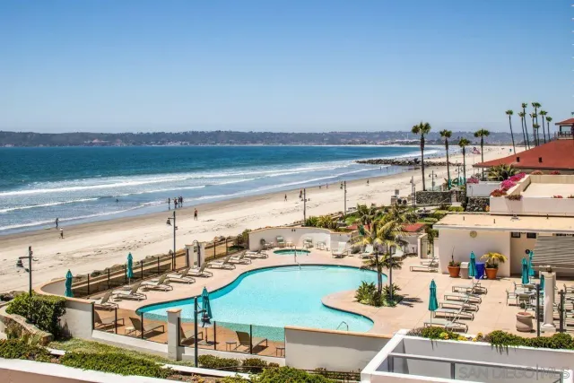 a view of a swimming pool with a table and chairs