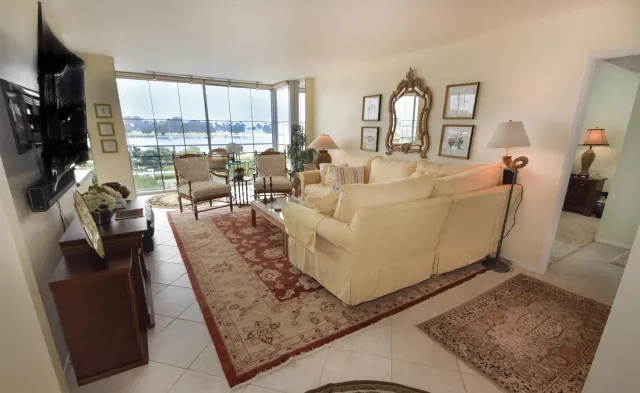 a living room with furniture rug and a large window